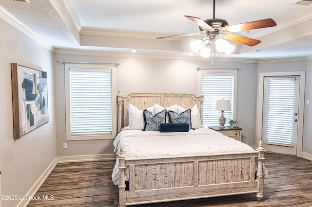 1510 Lancelot Ave, Wolfforth, TX 79382 - bedroom featuring dark wood-style flooring, a raised ceiling, ornamental molding, baseboards, and ceiling fan