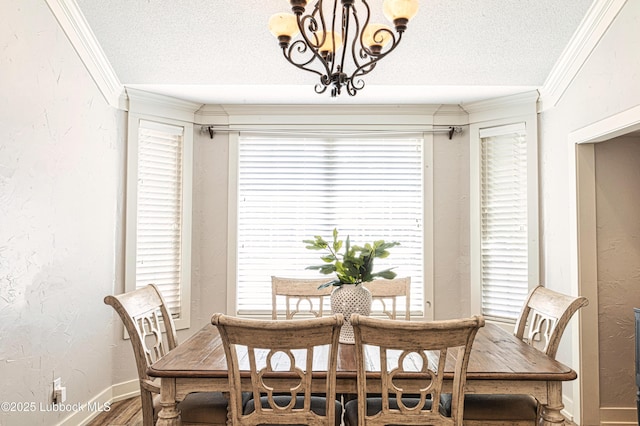 1510 Lancelot Ave, Wolfforth, TX 79382 - dining area featuring a textured ceiling, crown molding, wood finished floors, a chandelier, and baseboards