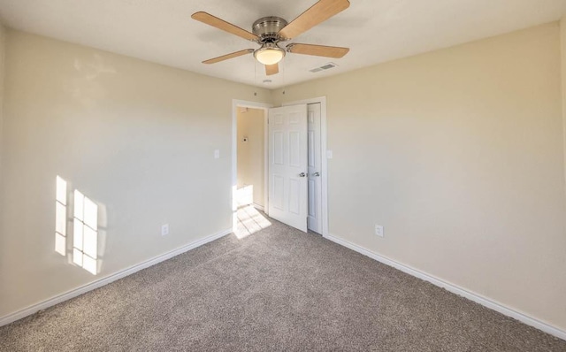 unfurnished room featuring ceiling fan and carpet floors