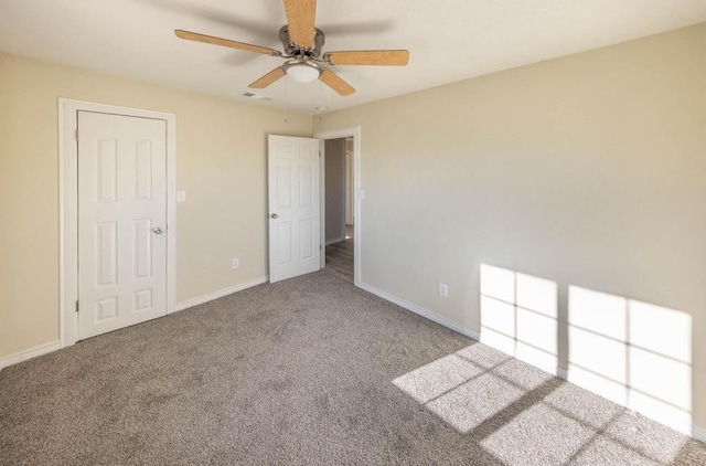 unfurnished bedroom featuring ceiling fan and carpet flooring