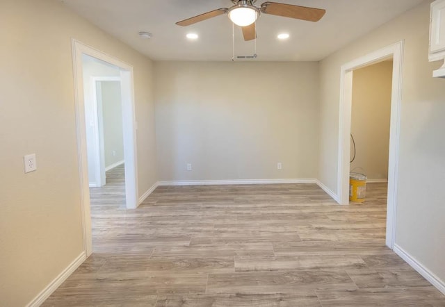 spare room with light hardwood / wood-style floors and ceiling fan