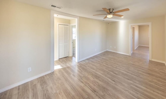 empty room featuring ceiling fan and light wood-type flooring