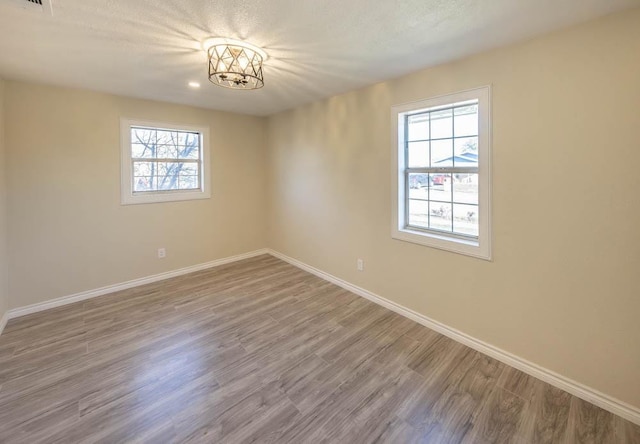 spare room with hardwood / wood-style floors