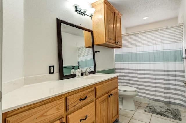 bathroom featuring tile patterned floors, toilet, vanity, and a textured ceiling