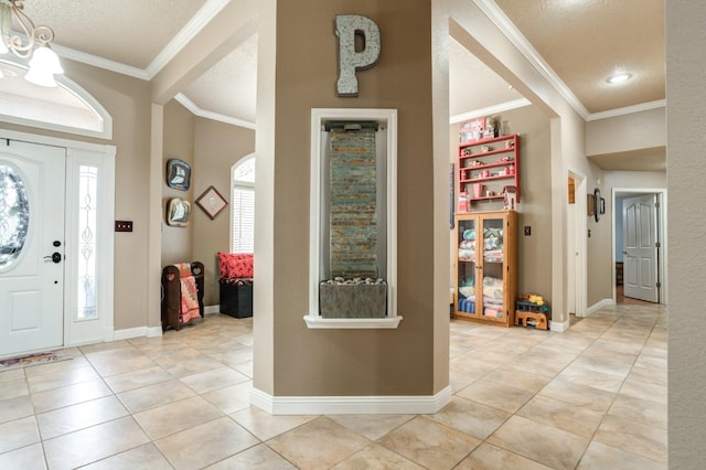 tiled foyer with crown molding and a textured ceiling