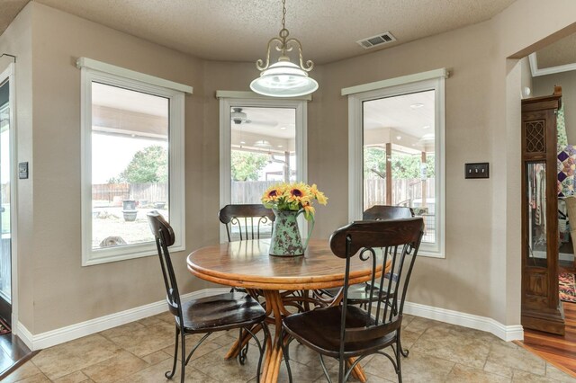 dining room featuring a textured ceiling