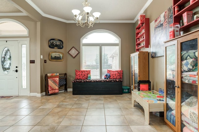 entrance foyer featuring tile patterned floors, ornamental molding, and a notable chandelier