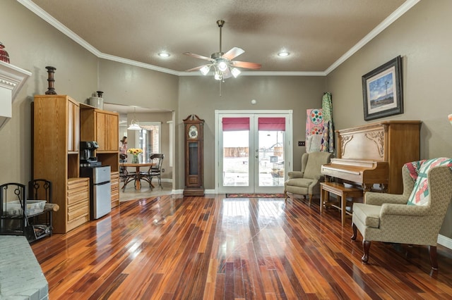 living area with crown molding, ceiling fan, dark wood-type flooring, and french doors