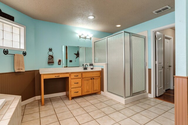 bathroom with vanity, tile patterned floors, a textured ceiling, and separate shower and tub