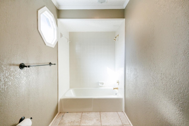 bathroom with tile patterned flooring, crown molding, and tiled shower / bath