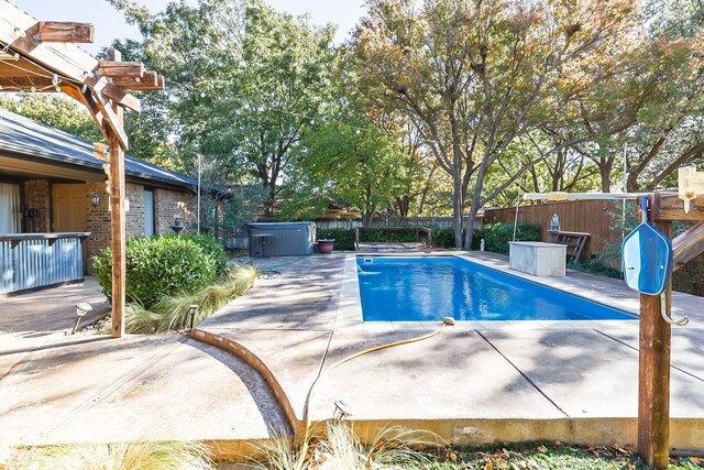 view of pool with a hot tub and a patio area