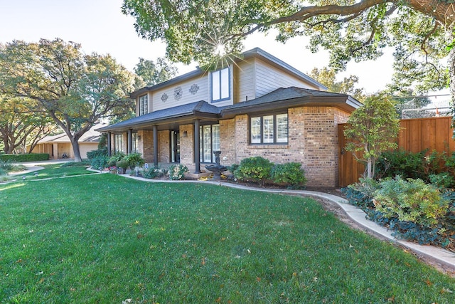 view of front of house with covered porch and a front yard