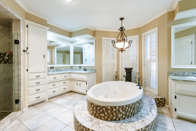 bathroom featuring vanity, tile patterned floors, a textured ceiling, and separate shower and tub