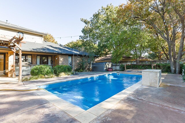 view of pool featuring a hot tub and a patio