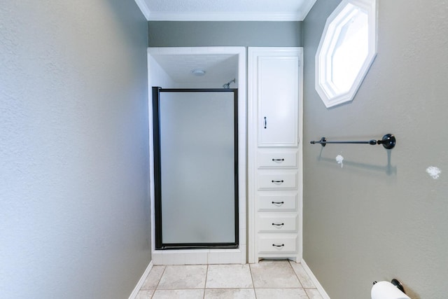 bathroom with an enclosed shower, ornamental molding, and tile patterned floors