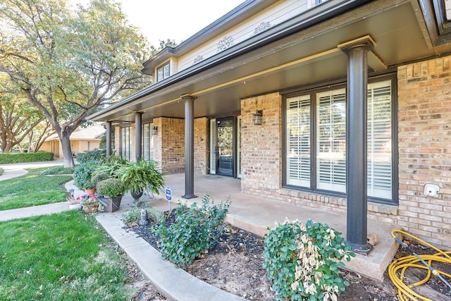 view of exterior entry with covered porch