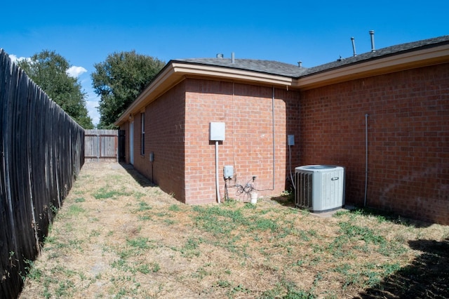 view of side of home featuring central AC unit