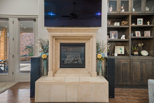 interior space featuring a high end fireplace and ceiling fan