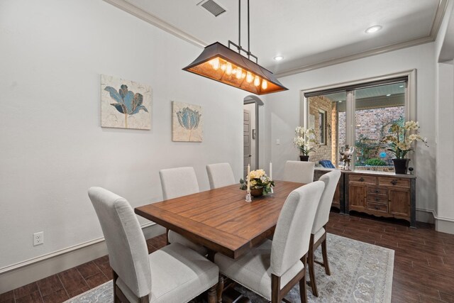 dining space featuring crown molding