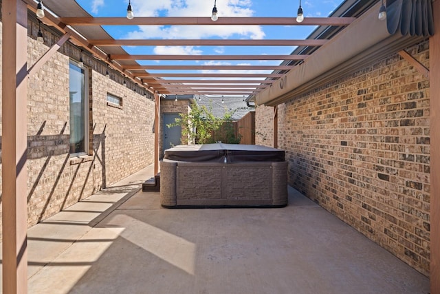 view of patio / terrace featuring a hot tub and a pergola