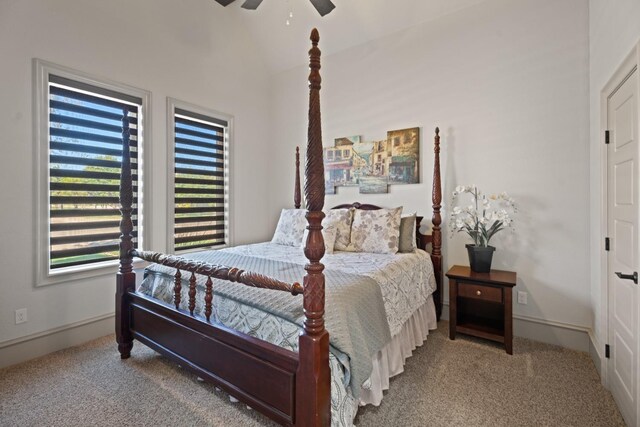 carpeted bedroom with lofted ceiling and ceiling fan