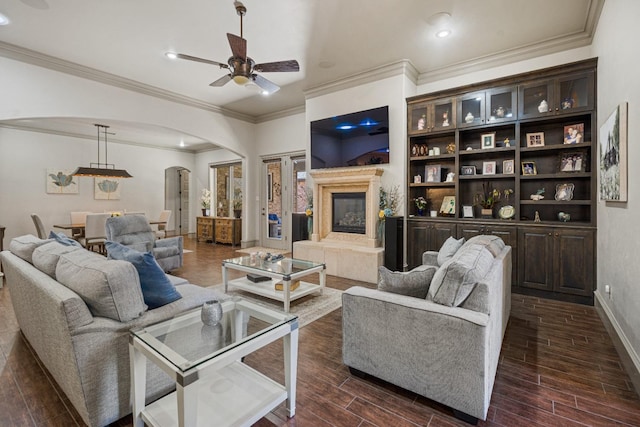 living room with a fireplace and ceiling fan