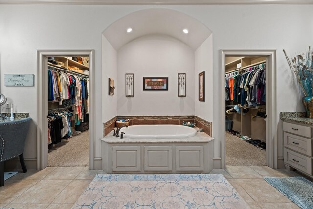 bathroom with tile patterned floors and a bathing tub