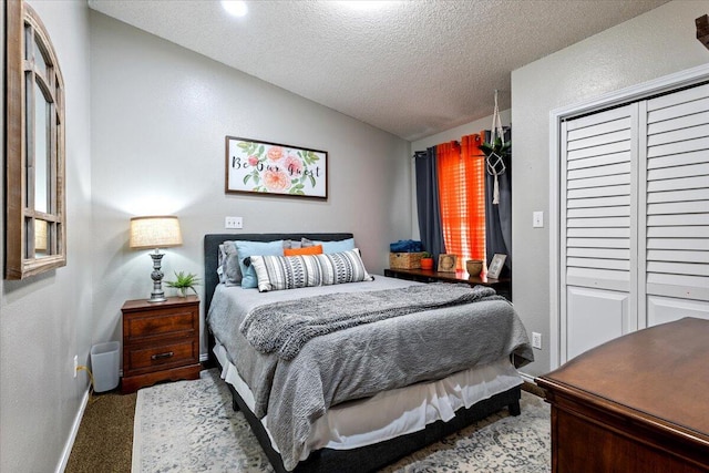 2917 Dove Ln, Denver City, TX 79323 - carpeted bedroom featuring lofted ceiling, a textured ceiling, baseboards, and a closet