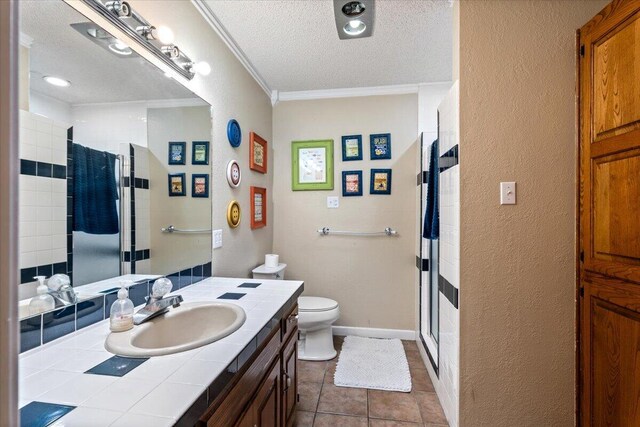 2917 Dove Ln, Denver City, TX 79323 - bathroom with a stall shower, a textured ceiling, ornamental molding, toilet, and vanity