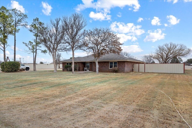 2917 Dove Ln, Denver City, TX 79323 - back of house with brick siding and a yard