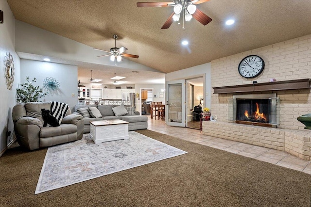 2917 Dove Ln, Denver City, TX 79323 - living area featuring lofted ceiling, a ceiling fan, carpet floors, a fireplace, and tile patterned floors