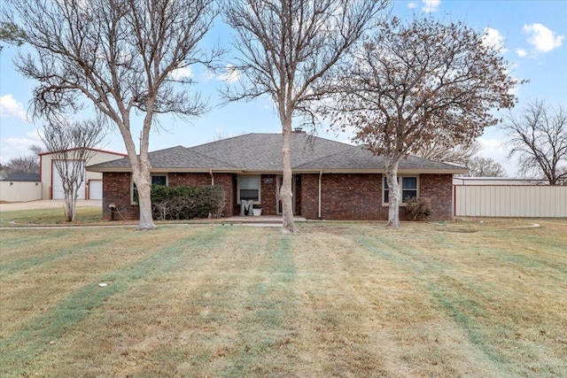 2917 Dove Ln, Denver City, TX 79323 - rear view of property featuring a lawn, brick siding, and a shingled roof