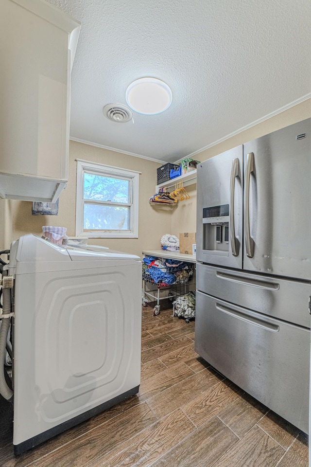 washroom with crown molding, washer / clothes dryer, visible vents, wood finished floors, and laundry area