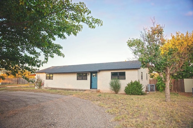 ranch-style home featuring central AC unit