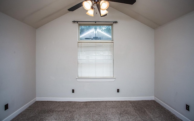 unfurnished room with dark carpet, vaulted ceiling, and ceiling fan