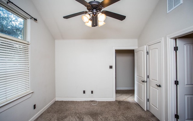 interior space with lofted ceiling, carpet flooring, ceiling fan, and a closet