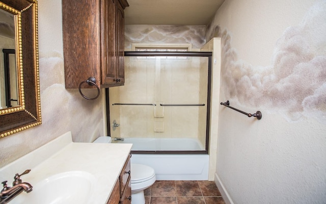 full bathroom featuring vanity, tile patterned floors, shower / bath combination with glass door, and toilet