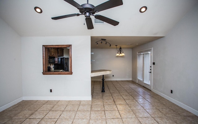 interior space featuring light tile patterned floors and ceiling fan