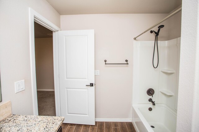 7314 29th St, Lubbock, TX 79407 - full bath featuring wood finished floors, vanity, and bathtub / shower combination
