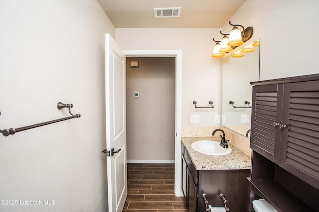 7314 29th St, Lubbock, TX 79407 - bathroom with vanity and wood finished floors