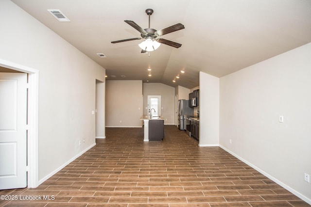 7314 29th St, Lubbock, TX 79407 - unfurnished living room with a ceiling fan, lofted ceiling, and dark wood finished floors