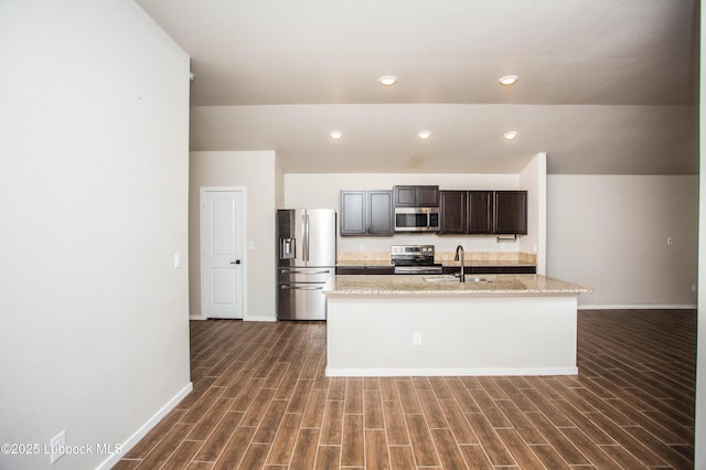 7314 29th St, Lubbock, TX 79407 - kitchen featuring appliances with stainless steel finishes, dark wood finished floors, recessed lighting, dark brown cabinets, and a center island with sink