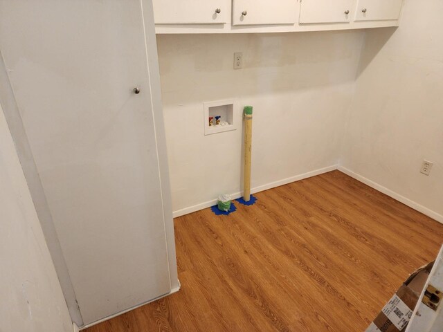 laundry room with cabinets, washer hookup, and light hardwood / wood-style floors