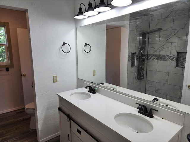 bathroom with hardwood / wood-style flooring, vanity, toilet, and an enclosed shower