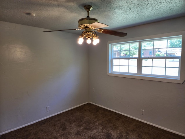 carpeted empty room with ceiling fan and a textured ceiling