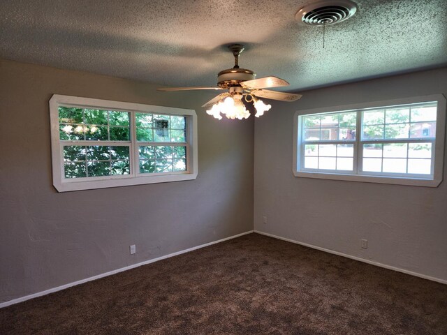 carpeted spare room with ceiling fan and a textured ceiling