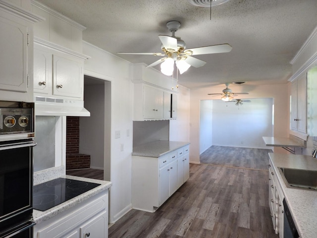 kitchen with dark wood-type flooring, sink, white cabinetry, a textured ceiling, and black appliances