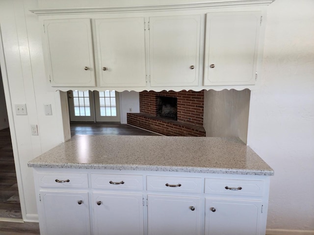 kitchen featuring white cabinetry and light stone counters