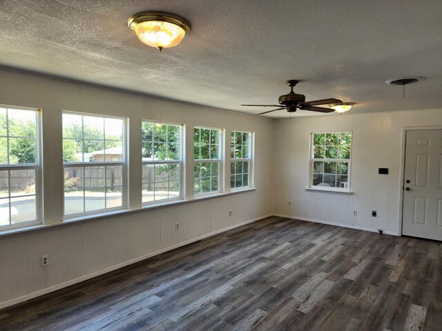 spare room with ceiling fan, dark hardwood / wood-style flooring, and a textured ceiling