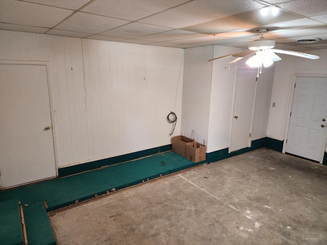 interior space with a paneled ceiling and concrete floors